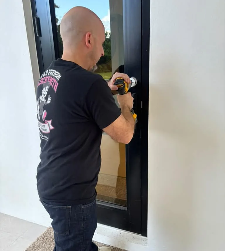 Oscar from A&O Premium Locksmith installing a multi-point lock on an impact-rated front door in Miami